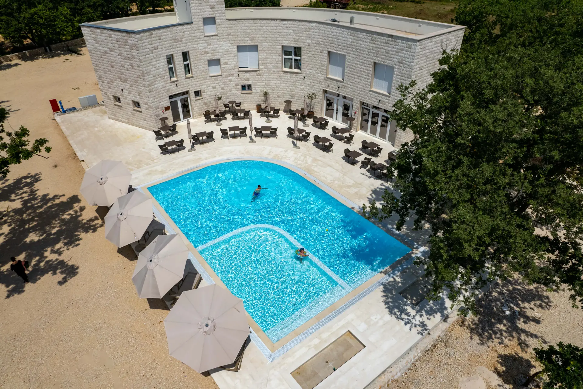 Person swimming in a large swimming pool