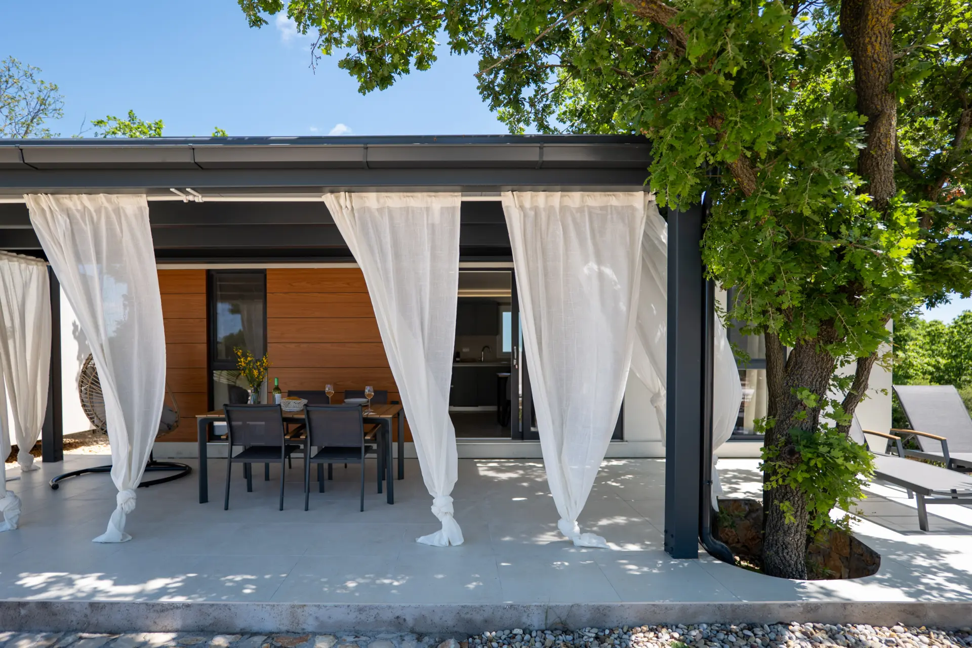 Table and chairs on a covered patio in a mobile home campsite